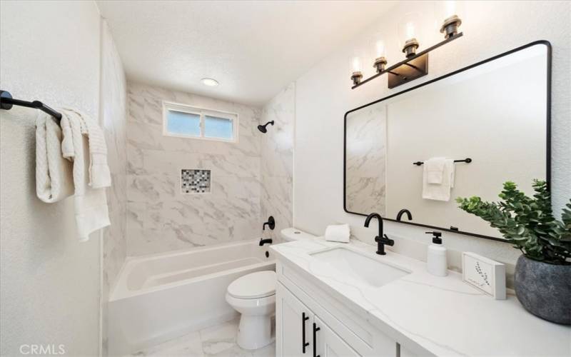 Fully updated bathroom with a quartz counter, medicine cabinet and plenty of storage in the 2 linen closets in the hallway.