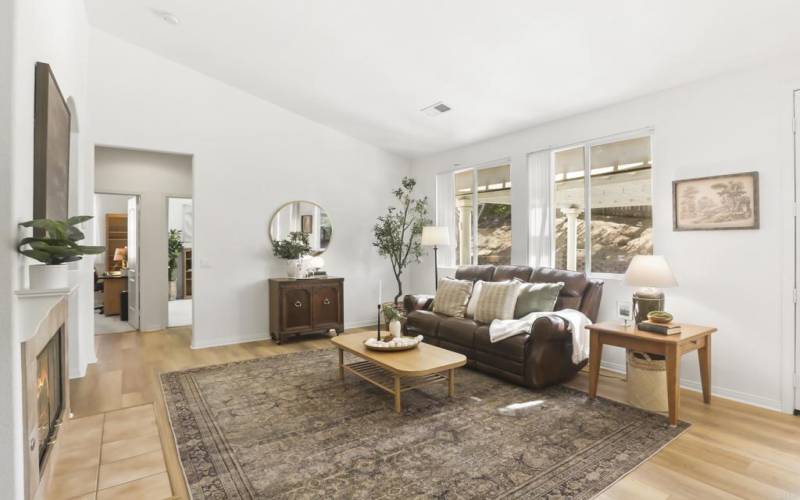 Family Room with large windows and glass door to the backyard patio and a cozy fireplace & gas logs