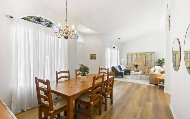 Large windows and vaulted ceilings in this open concept Living Room and Dining Room