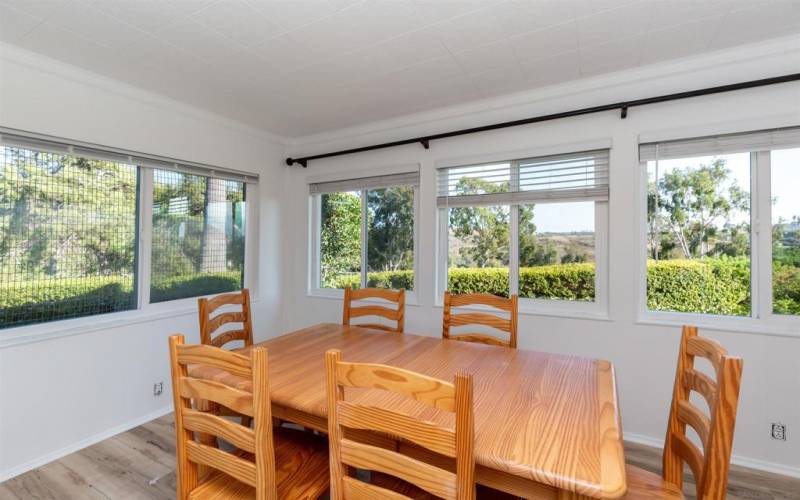 This finished screened porch is used as formal dining with French Doors, can be used for office, den, workout, looks out directly on grassy area and golf course