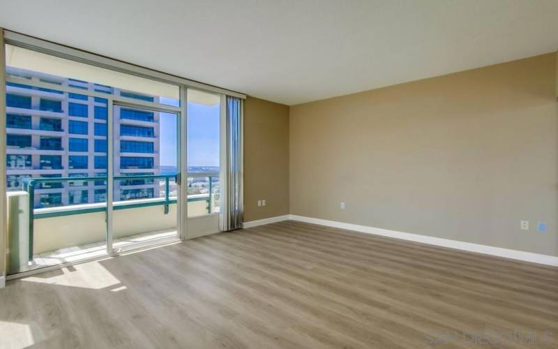 Spacious primary bedroom with private balcony.