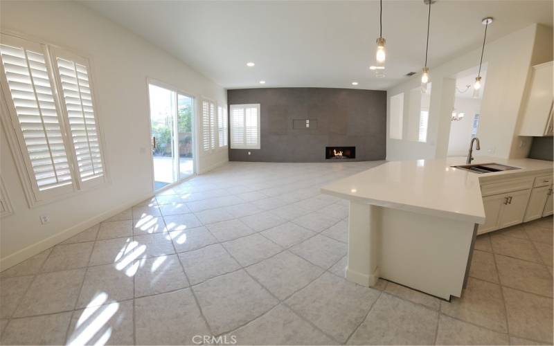 Open Concept Family Room and Kitchen with space for Big Screen Mounted TV. Cozy Gas Fireplace with Sparkling Fire Glass. All newly installed Canned Lighting throughout.