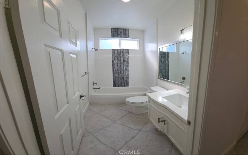 Gorgeous 2nd bathroom has been renovated with Quartz Countertops and newly tile tub surround.