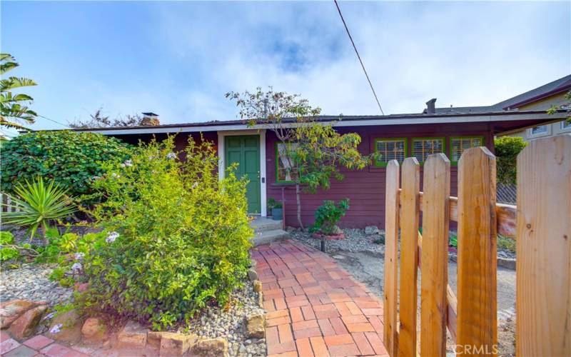 Red brick paved walkway leading to the front door.