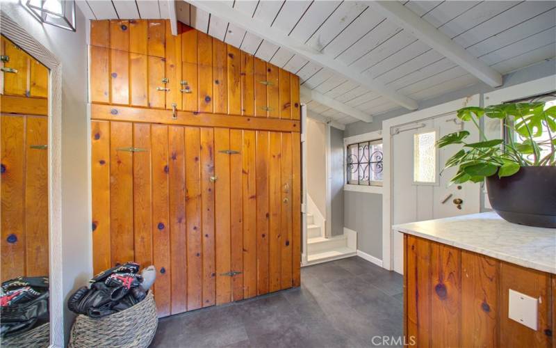 Cabinets besides the stairs that lead you back up to the main level and front of house.