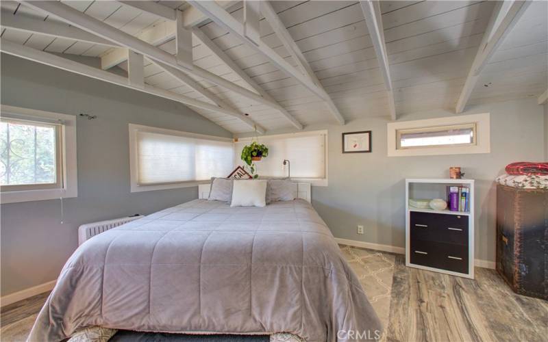 Original windows and vinyl flooring in master bedroom.