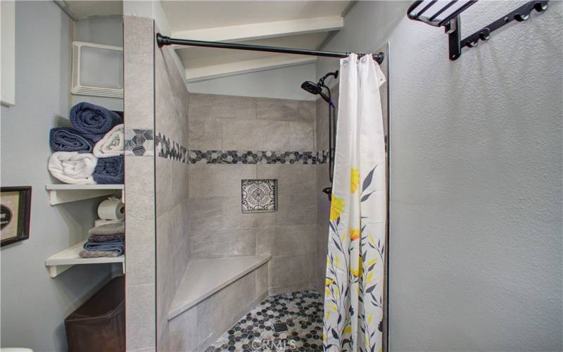 Tiled walk-in shower in master bathroom.