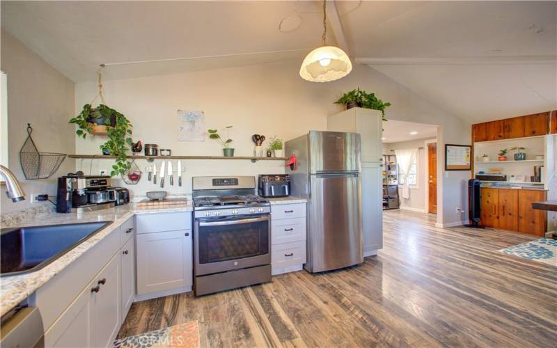 Kitchen features an open layout leading to the hard floored dining area.