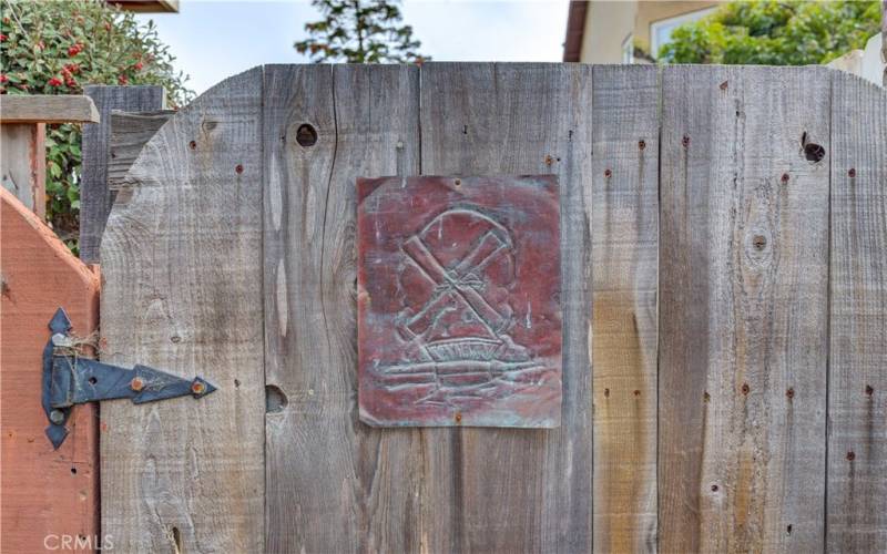 Etched artwork displayed on right side yard gate.