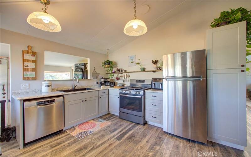 Stainless steel appliances and classic overhead light fixtures.