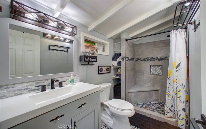 Updated master bathroom with modern sink and cabinets.