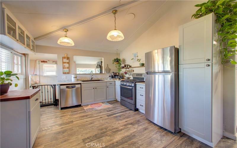 Updated kitchen with modern cabinets and countertops.