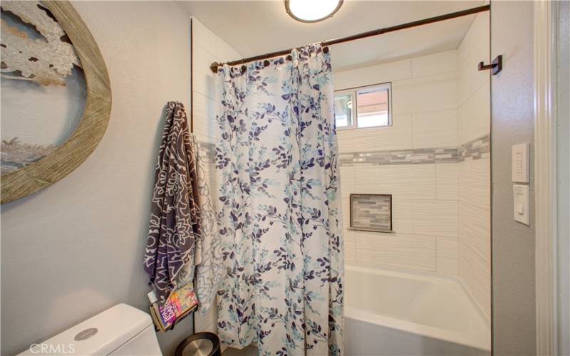 Updated bathtub-shower in first bathroom.