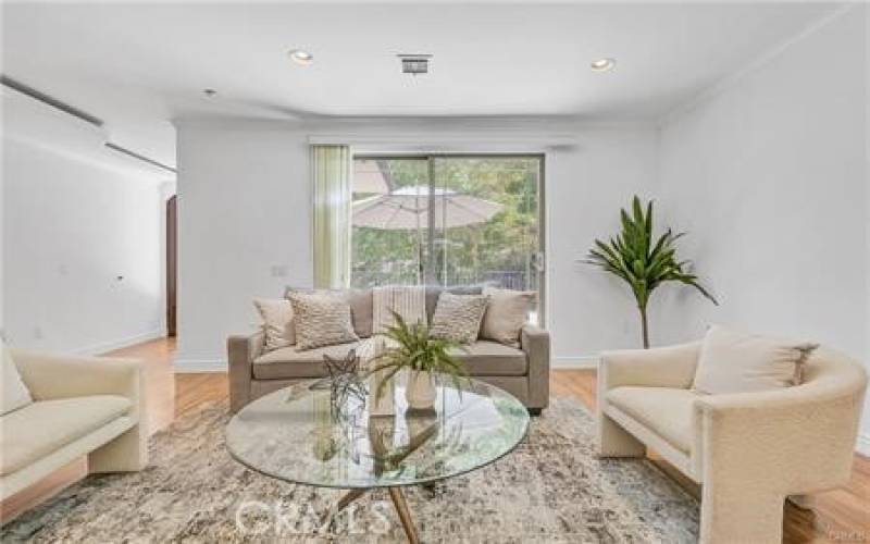 Living room with high ceiling & fireplace opens to the patio - perfect indoor / outdoor entertaining