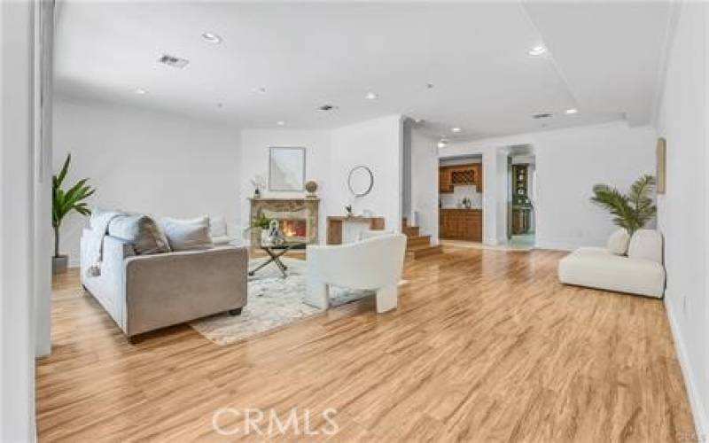 Living room with high ceiling & fireplace opens to the patio - perfect indoor / outdoor entertaining