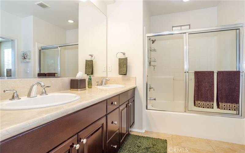 Sumptuous private master bath features gorgeous marble counter tops with dual sinks, large mirror