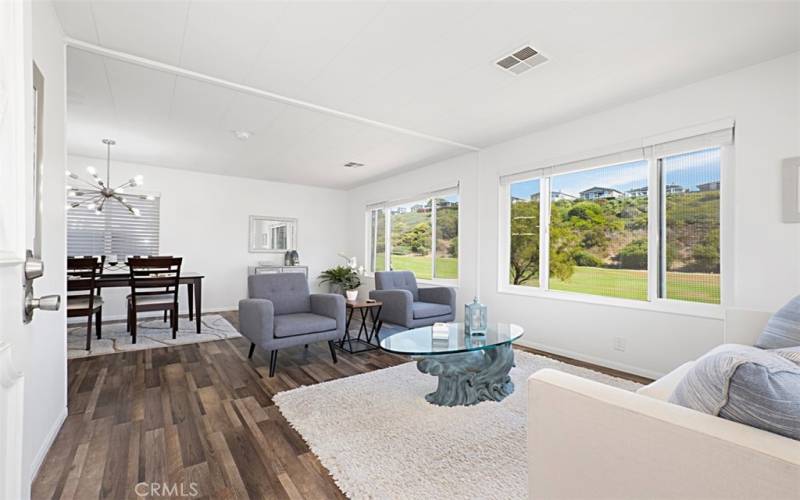 walk through the front door to enter the Living room with golf course view