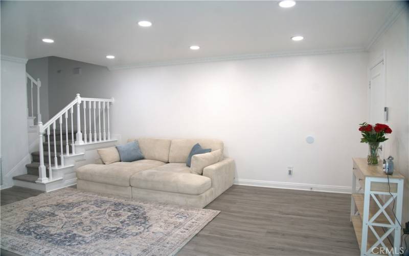 Living Room with updated lighting, wood flooring, paint