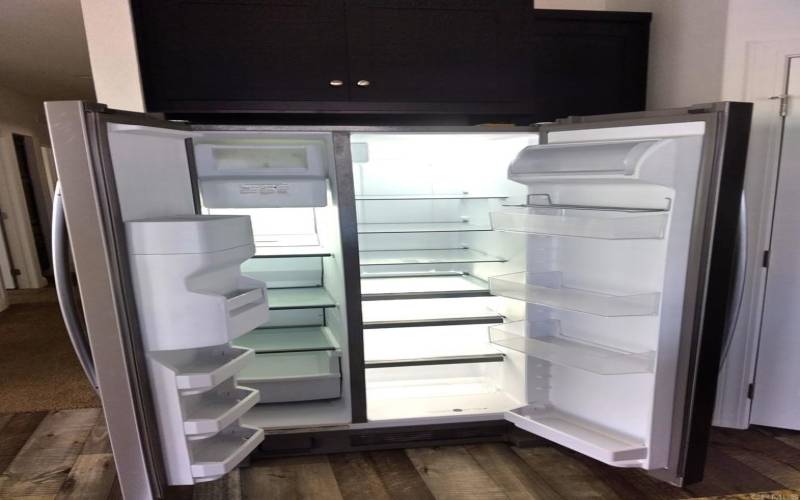 Sparkling clean brand-new fridge with ice and wate