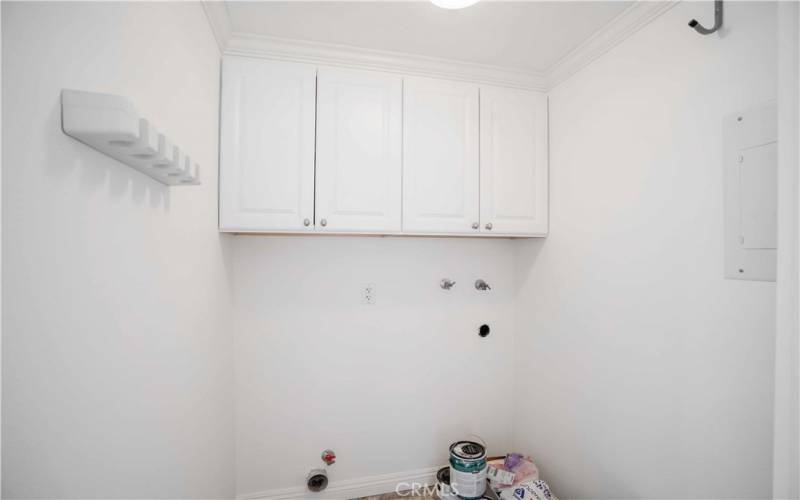 Inside laundry with cabinets