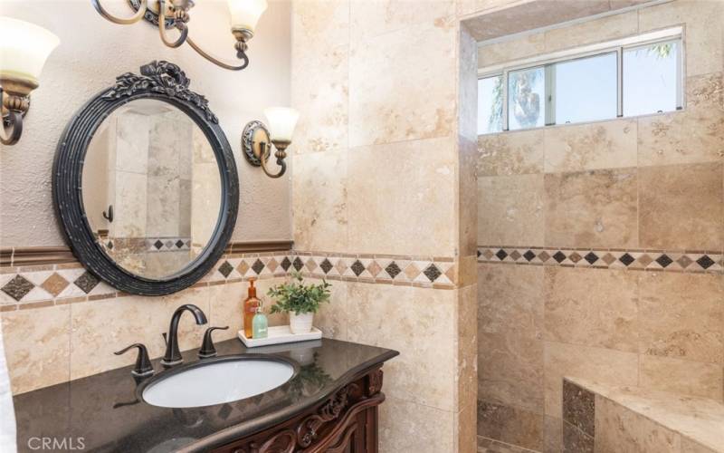 This home offers plenty of bathrooms, including this beautiful designed space with elegant fixtures and a spacious walk-in shower.