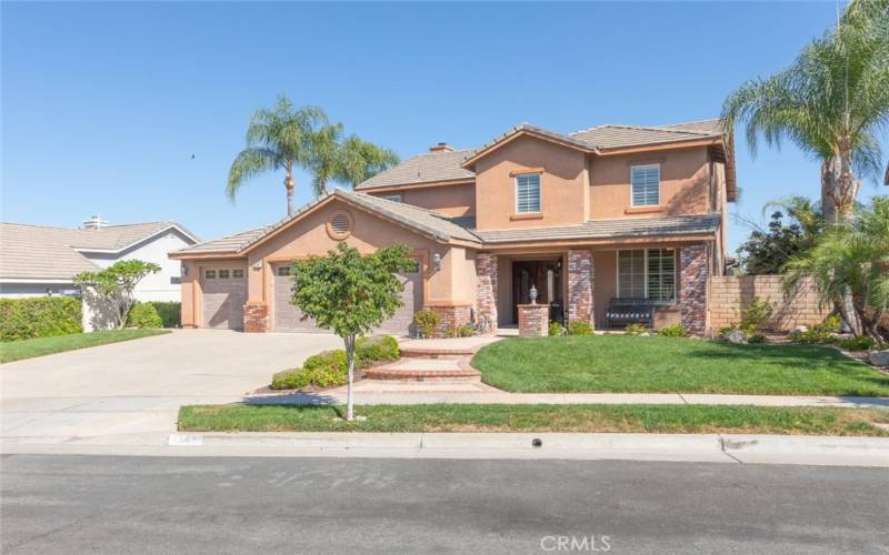 This home has well-manicured landscaping, charming brick accents, and inviting front porch.