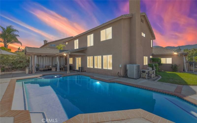 
This beautiful backyard features a sparkling pool and spa, perfect for relaxation, along with a covered patio area for outdoor lounging.