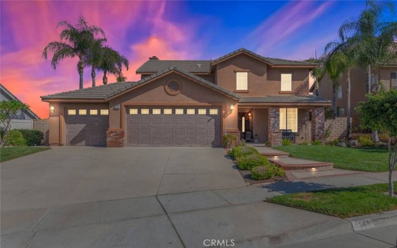 This beautiful two-story home features a spacious driveway, a three-car garage, and well-maintained landscaping.