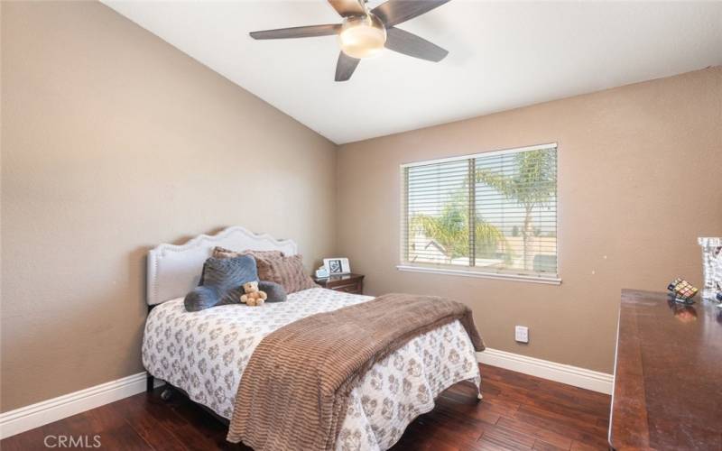 This spacious home offers plenty of bedrooms, each featuring large windows and ceiling fans