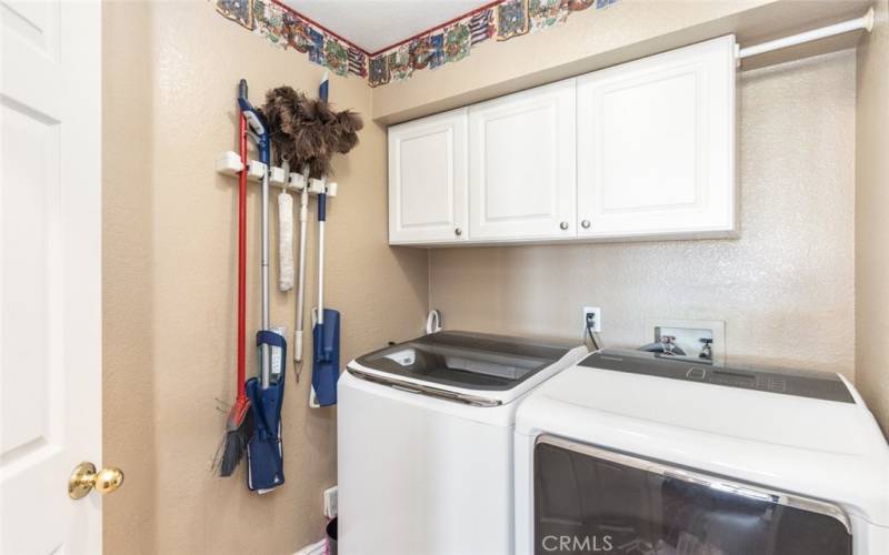 The home offers the convenience of a separate laundry room with storage.