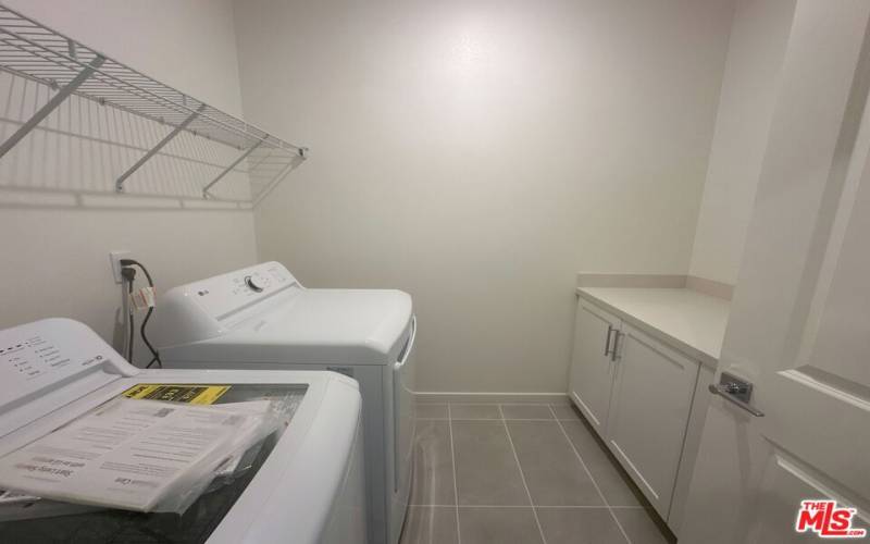 Laundry room with side-by-side appliances included