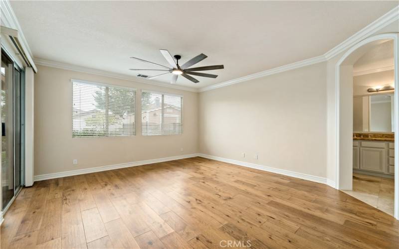 Master bedroom with upgraded baseboards, crown molding and oversized ceiling fan.