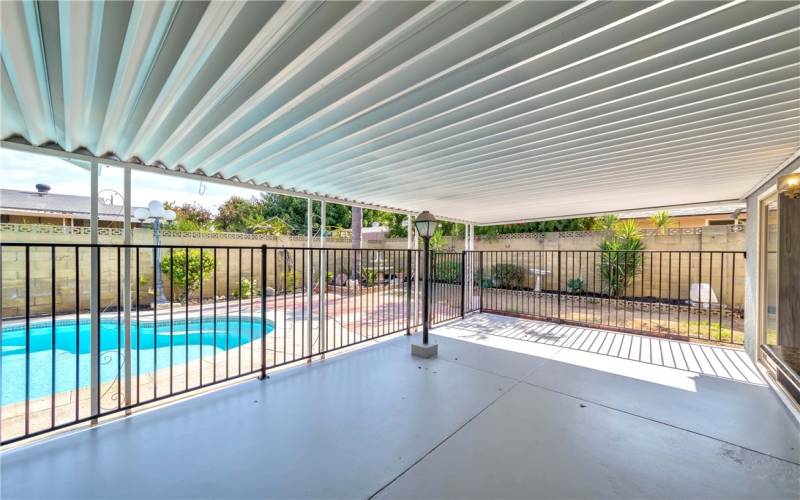 covered patio and fenced pool area for safety