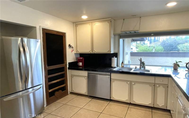 Kitchen with door to Garage. Easy for Grocery Haul!