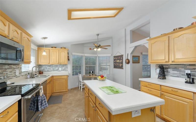 Fabulous island kitchen with tile floors and dinette with ceiling​​‌​​​​‌​​‌‌​​‌​​​‌‌​​​‌​​‌‌​​‌‌​​‌‌​​​​ fan.