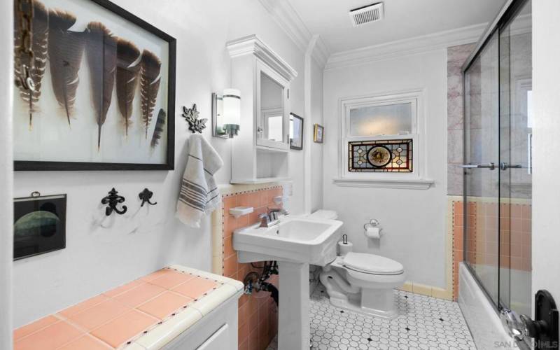 Bathroom in main house features original details & tile.