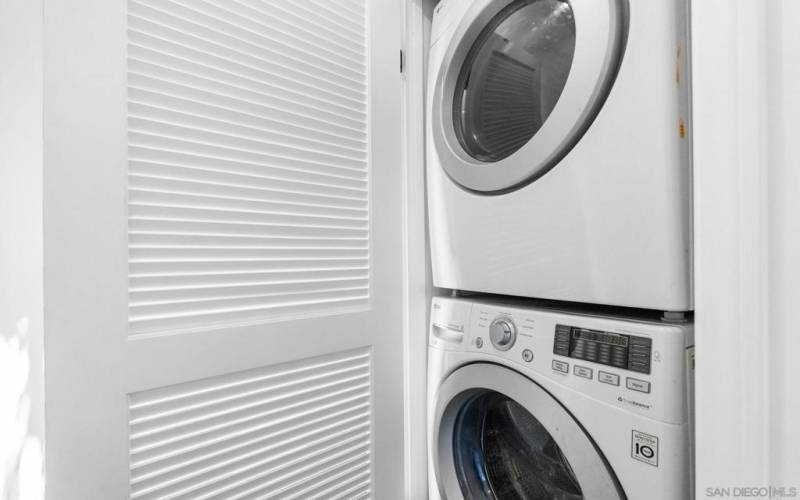 Stacked laundry in guest suite.