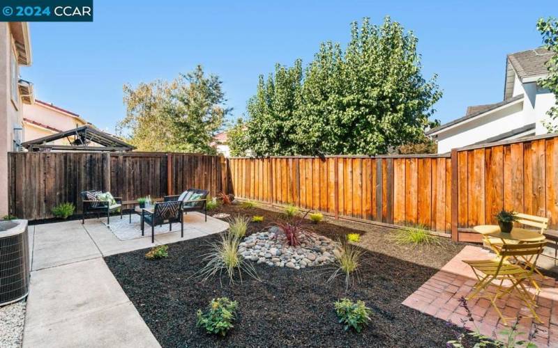 View of the backyard landscaping and side area.