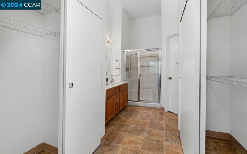 View of the primary bathroom with closets from the bedroom.