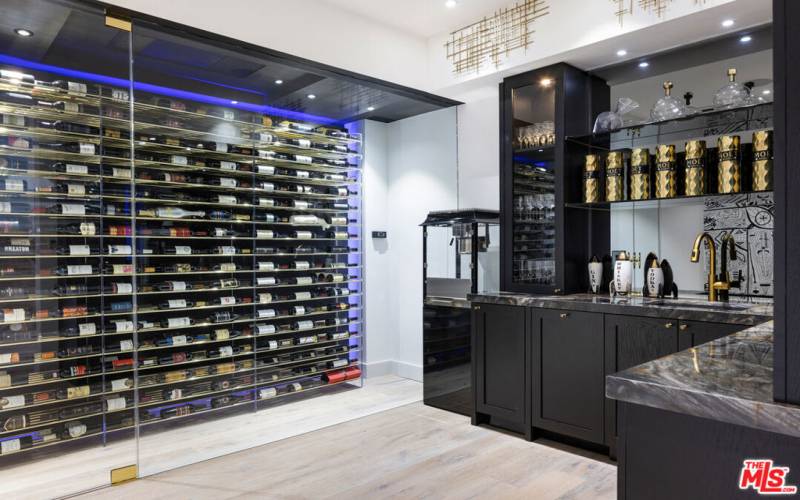 486 bottle backlit temperature controlled wine cellar with wet bar off theater in lower level.