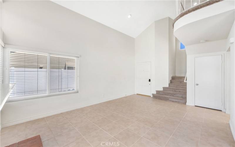 Living room with stairs to second floor.