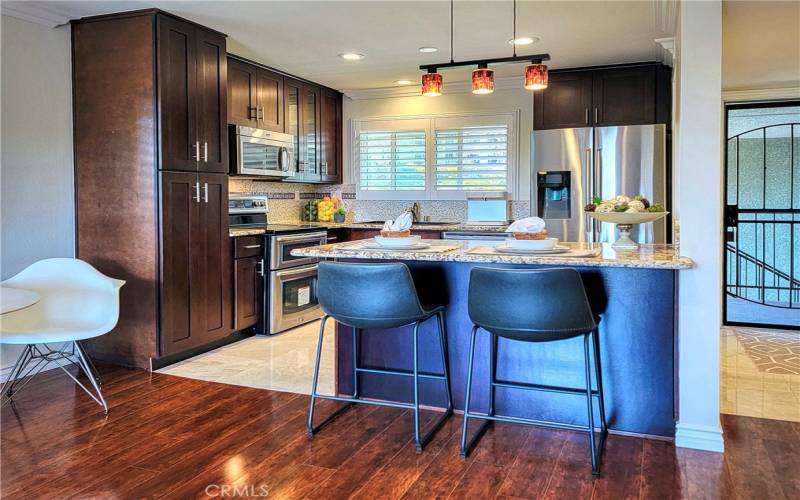 Custom cabinets and an open kitchen with granite counter tops for eating at this spacious counter.