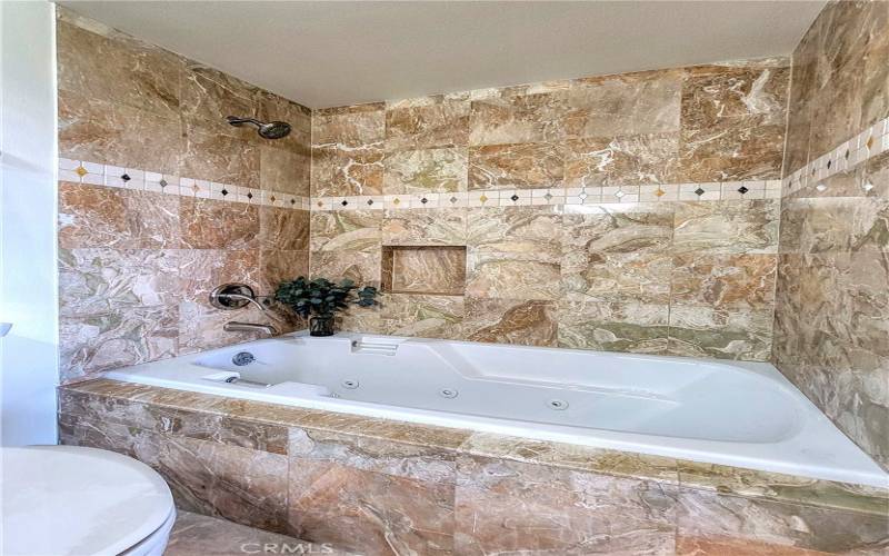 Beautifully tiled bath with jacuzzi tub.  Your spa is ready...