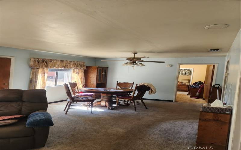 Dining area with second bedroom beyond