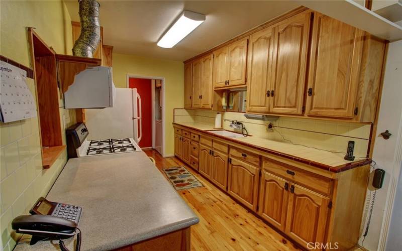 Real photo of the large kitchen with beautiful hickory cabinets.