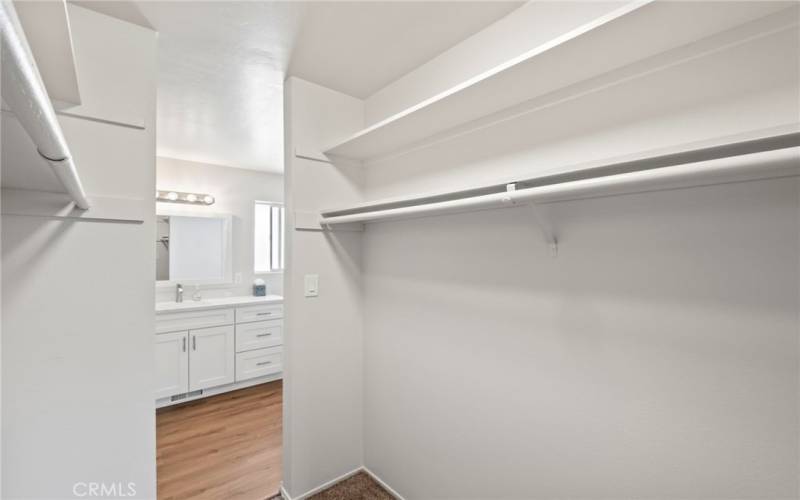 Primary 'Jack-n-Jill' walk-in closet between bedroom and bathroom