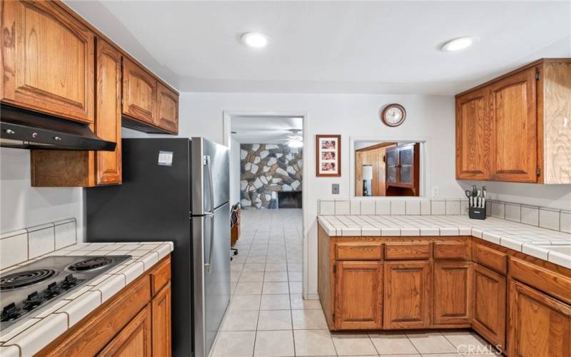 Kitchen view into family room with fireplace