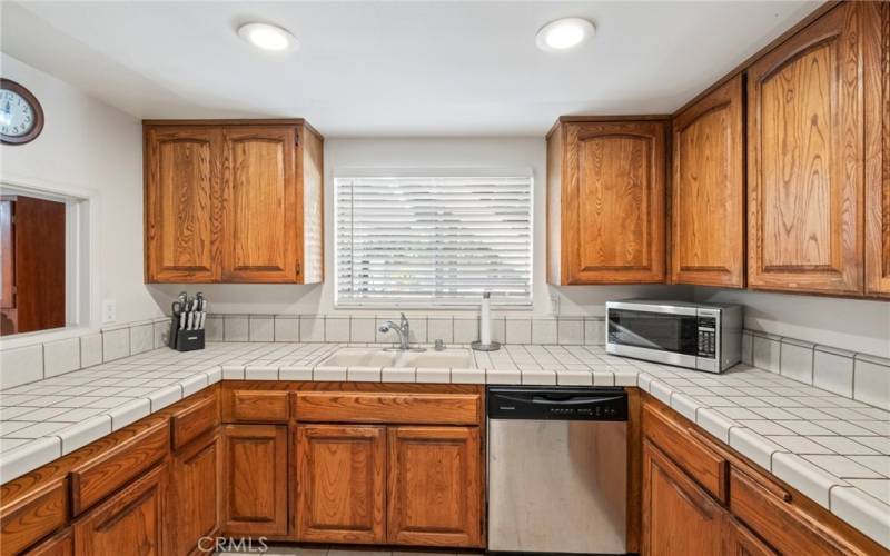 Kitchen window over double sinks looks out to the pool and backyard!