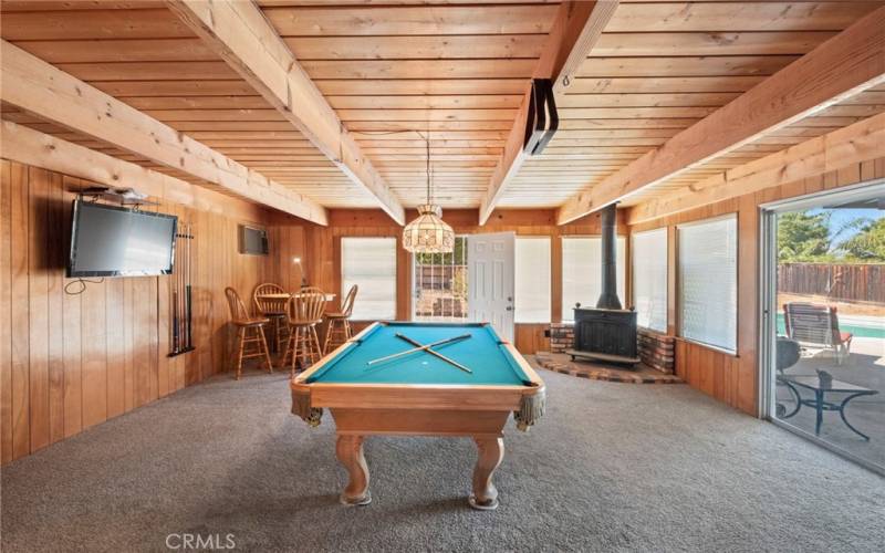 Bonus/Game Room with Wood paneled ceiling and glass sliders out to the entertaining backyard!