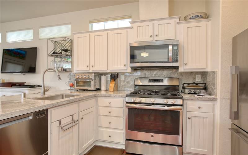 Top of the line stainless appliances include Fisher & Paykel refrigerator and two drawer dishwasher, GE 5 burner gas range with grill, Stainless farmhouse sink and quartz counters.